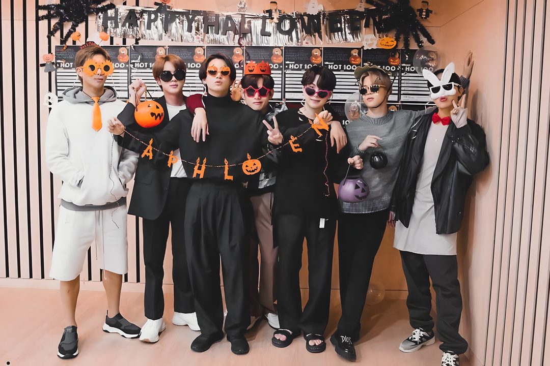a group of people standing next to each other in front of a wall with halloween decorations Bts Halloween Laptop Hottest 100, Foto Jungkook, Bangtan Boys, Varsity Jacket, Bts, gray