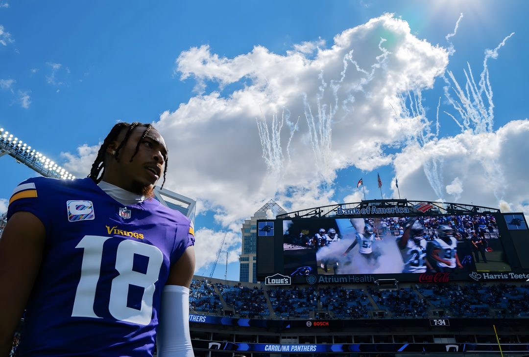 a football player standing in front of a large screen Justin Jefferson Halloween steel blue