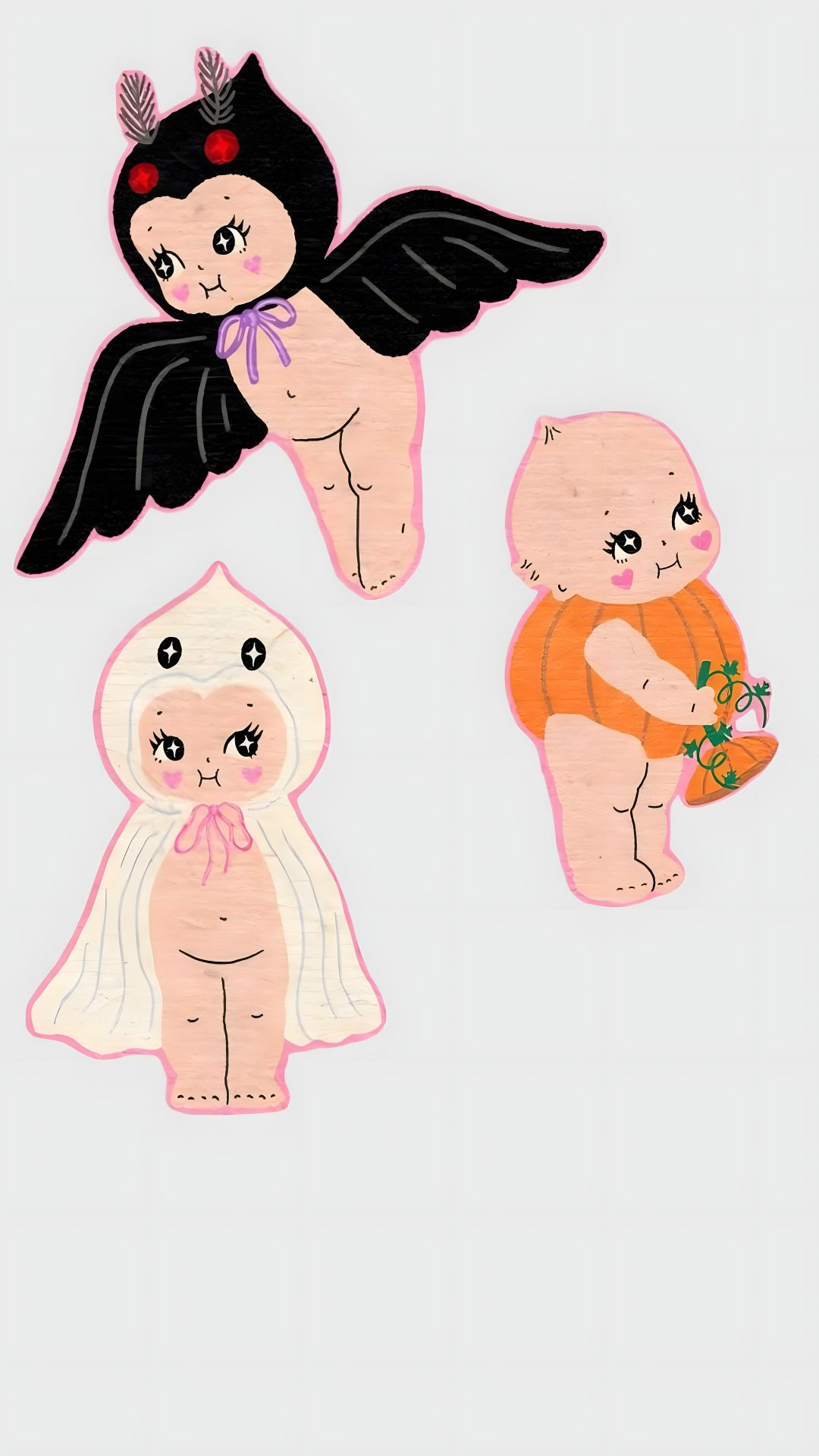 three small stickers with angels on them, one in the air and one in the ground Kewpie Halloween gainsboro
