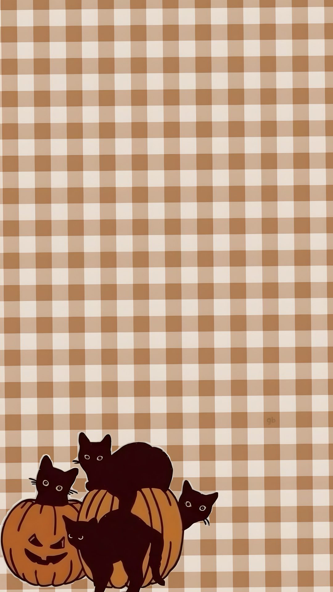 two cats sitting on top of a pumpkin in front of a checkered tablecloth Halloween Checkered tan