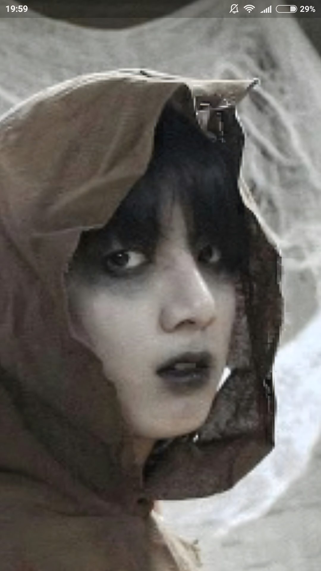 a woman with black hair and makeup wearing a brown hood over her head, looking at the camera Jungkook Halloween Historical Figures, dark olive green