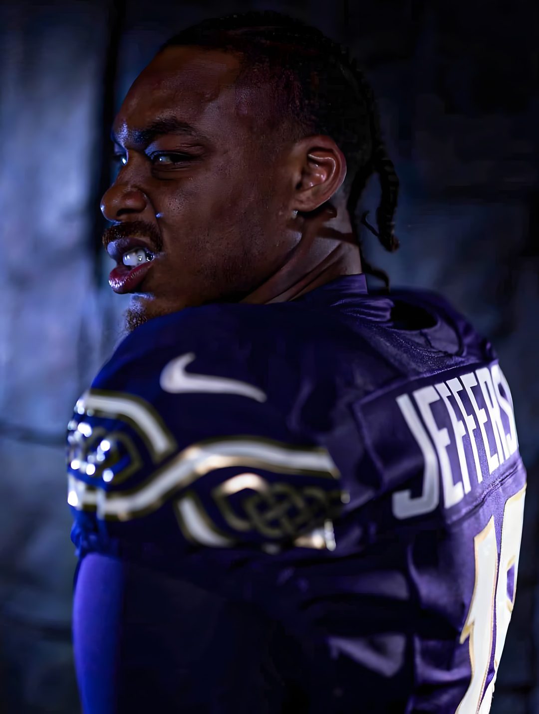 a football player with dreadlocks is posing for a photo in the dark room Justin Jefferson Halloween black