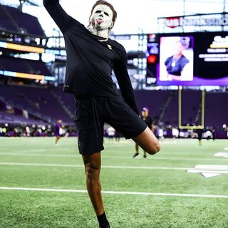 a man wearing a mask and black shorts standing on top of a field with his hands in the air Justin Jefferson Halloween Justin Jefferson Pfp 4k, Justin Jefferson Halloween, Jjetas, dark sea green