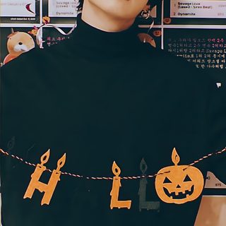 a woman wearing sunglasses and a black sweater with pumpkins on it, standing in front of a poster Jungkook Halloween Bts Halloween Costume, Jungkook Halloween, Bts Pumpkin Painting, dark slate gray