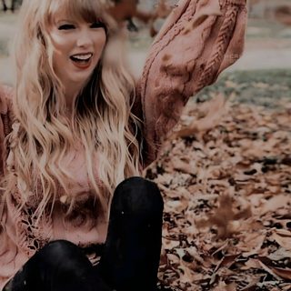 a woman sitting on the ground with her arms in the air and leaves all around her Halloween Taylor Swift Taylor Swift Fall Photoshoot, Taylor Swift Fall, Taylor Swift Happy Aesthetic, dark olive green