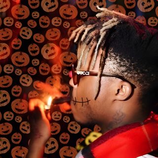 a young man with dreadlocks holding a lit candle in front of halloween themed background Halloween Juice Wrld Juice Wrld Ghost, Juice Wrld Christmas Pic, Juice Wrld Santa, saddle brown