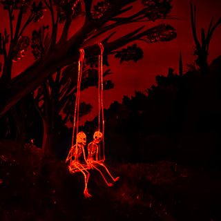 a skeleton sitting on a swing in the dark with red light coming from behind it Red Halloween Aesthetic Red Skeleton, Red Creepy, Utility Pole, Red, black