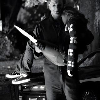 a man and woman standing next to each other in front of a car at night Halloween 2007 Michael Myers Jason Voorhees, Halloween 2007, Jason And Michael Myers, Michael Myers Hug, black