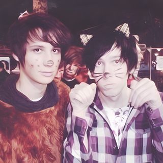 two young men standing next to each other in front of a crowd with fake cats on their faces Dan And Phil Halloween 2009 Dan And Phil Halloween, Dan Howell 2010, Phan Proof, Dan And Phil Makeup, dim gray