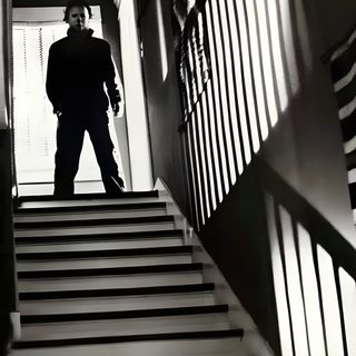 a man standing on top of a set of stairs John Carpenter Halloween Michael Myers Standing In Shadows, Michael Myers Stairs, Michael Myers In Shadow, dark slate gray