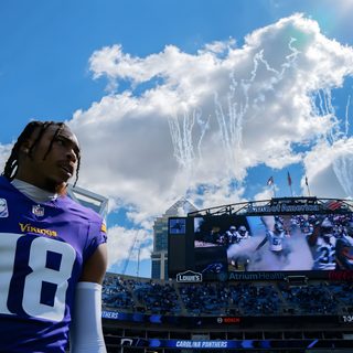 a football player standing in front of a large screen Justin Jefferson Halloween steel blue