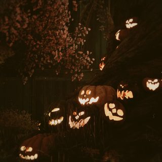 pumpkins carved into the faces of jack - o'- lanterns on display at night Applewatch Halloween Aesthetic Halloween Pfps, 2000s Halloween Vibe, Halloween Aesthetic Images, black