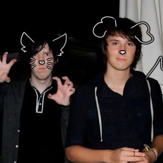 two young men standing next to each other in front of a flag with cats drawn on it Dan And Phil Halloween 2009 Dan And Phil, black