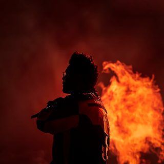 a man standing in front of a fire with his back to the camera and arms around him The Weeknd Halloween The Weeknd Background, The Weeknd Iphone, The Weeknd Albums, Starboy The Weeknd, black
