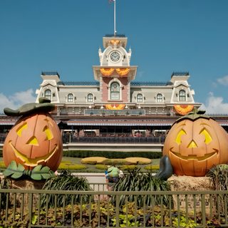 two carved pumpkins in front of a building with a clock tower on the top Disney World Halloween Pumpkin, Disneyland Pumpkin, Disney World Halloween, slate gray