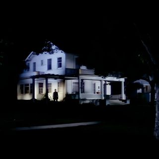 a large white house sitting in the middle of a forest at night with lights on Halloween 1978 4k Poltergeist House, Amityville Ghost Boy, Black Christmas 1974 House,