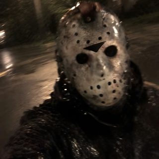 a person wearing a mask and chains on the street at night with trees in the background Jason Halloween Jason Voorhees Scary, Jason Universe, Jason Walpaper, Jason Voorhees Hq, black