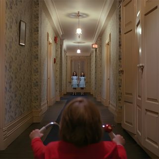 the woman is walking down the hallway with her hand up in the air as she takes a photo The Shining Laptop Halloween The Shining Movie Aesthetic, The Shining Stills, The Shining Scene, dark olive green