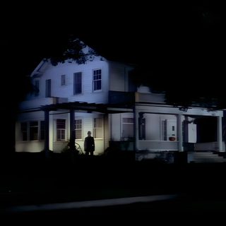 a person standing in front of a house at night with the light on and behind him Halloween 1978 Scream Music, Halloween 1978, Scary Films, A Place For My Head, Halloween Film, black