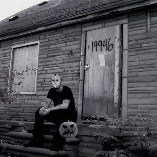 a man sitting on steps in front of a brick building with graffiti written on it Eminem Halloween All Eminem Albums, Red & Black Eminem, Eminem Cover Photo, dim gray