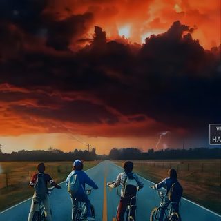 three children riding bikes on an empty road under a cloudy sky with lightning in the distance Stranger Things Halloween Stranger Things Anime, Iphone Stranger Things, Stranger Things Tumblr, black