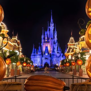 pumpkins are lit up in front of the castle at disney's halloween wonderland Walt Disney World Halloween Cinderella Castle At Night With Pumpkins, Disney Halloween Event Ideas, Fall Family Vacation Spots, saddle brown