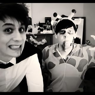 two people dressed up in costumes posing for the camera while one person is holding out his hand Dan And Phil Halloween 2009 Dan The Dinosaur, Demon Giraffe, Dinosaur Dan, Zombie Giraffe, dim gray