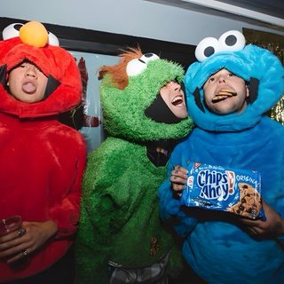 three people dressed in sesame street characters posing for a photo with one holding a candy bar 5sos Halloween 5sos Christmas, Ashton And Drake, 5sos Halloween, dark slate gray
