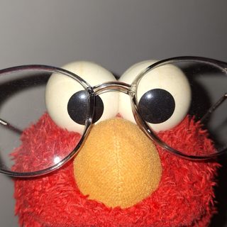 a close up of a stuffed animal wearing glasses Elmo Halloween Funny Backgrounds Elmo, Pfp For Contacts, Elmo X Eyes, Elmo Halloween, dim gray