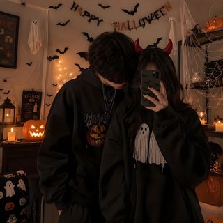 a man and woman taking a selfie in front of halloween decorations Halloween Couple Iphone black