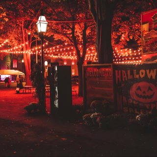 an outdoor area with lights and decorations on the trees Salem Halloween Aesthetic Halloween Theater, Salem During Fall, Salem Fall Aesthetic, dark slate gray