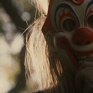 a woman wearing a clown mask with long blonde hair is holding her face up to the camera Halloween 2007 Rob Zombie Halloween Movie, Friday The 13th Rob Zombie, Halloween 2 Rob Zombie, dark olive green