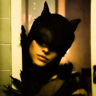 a woman wearing a cat costume in front of a mirror Ariana Grande Halloween Ariana Grande, Catwoman Movie Poster, Ariana Grande Photos, dark olive green