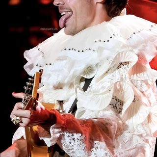 a man in a white dress holding a guitar and singing into a microphone with his mouth open Harry Styles Happy Halloween Iphone Harryween Night 2, Harryween, Nikki Marie Twitter, indian red