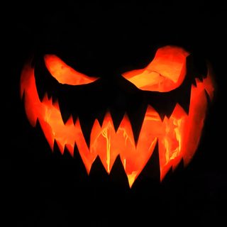 a carved pumpkin with glowing eyes in the dark Black And Orange Halloween Evil Pumpkin, Black Light Posters, Halloween Backgrounds,