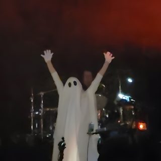 a man in a ghost costume standing on stage with his hands up and arms wide open Mcr Halloween Mcr Memes, Frank Iero, Gerard Way, Kid Memes, Music Memes, My Chemical Romance, black