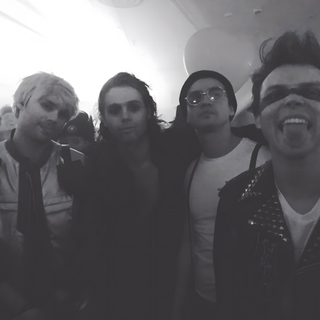 a group of young men standing next to each other 5sos Halloween 5sos Halloween, 5sos Halloween Costumes, Michael Clifford Halloween, dark slate gray