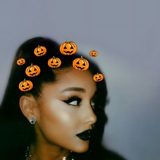 a woman with black makeup and orange pumpkins on her head is shown from the side Ariana Grande Halloween Ariana Grande Pumpkin, Ariana Grande Jack Skellington, Ariana Grande Fall, gray