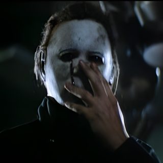 a man with red hair and makeup is holding his hand up to his mouth in the dark Halloween 2 2009 Original Halloween Movie, Halloween 2 2009, Halloween 2 1981 Pumpkin, black
