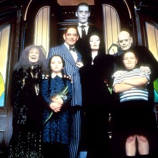a group of people standing in front of a door with halloween decorations on the doors Halloween Family Cameos Adam Family Costume, Addams Family Lurch, Addams Family Group Costume, black