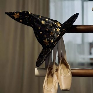 a pair of ballet shoes hanging from a rail with a hat on top of it Halloween Ballerina Ballerina Witch, Witches Dance, Cover, Witch Aesthetic, dark olive green