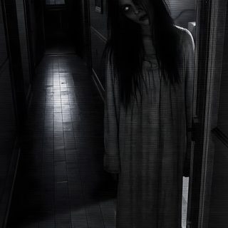 a woman standing in a dark hallway with her hair blowing back and eyes wide open Really Scary Halloween black
