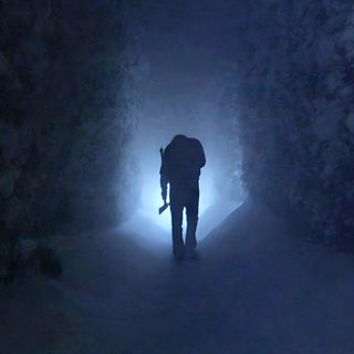 a person standing in the middle of a dark tunnel with snow on the ground and trees The Shining Laptop Halloween The Shining 1980 Hedge Maze Snow Scene, The Shining 1980 Movie Stills, The Shining Jack In The Snow, dark slate gray