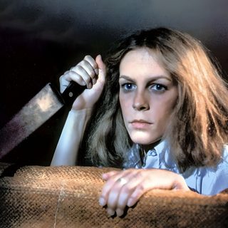 a woman sitting on top of a couch holding a knife Halloween 1978 Halloween Movies In Order, Laurie Strode, Halloween 2 Laurie Strode, dark slate gray