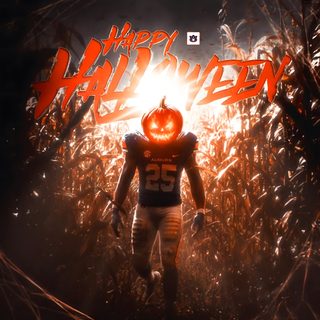 a football player with an orange pumpkin on his face in the middle of a cornfield Cool Halloween Football Auburn Football, Auburn, Happy Halloween, Football, Halloween, black