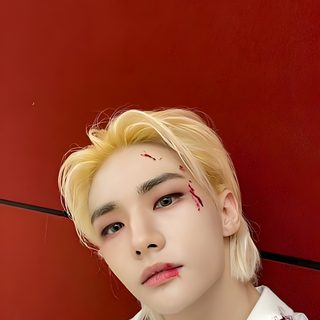 a young man with blood on his face sitting against a red wall and wearing a white shirt Hyunjin Halloween Hyunjin Joker Make Up, Hyunjin Joker Costume, Stray Kids Halloween Background, brown