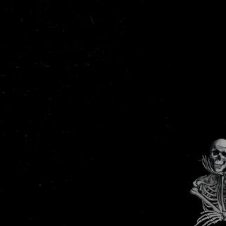 a skeleton sitting on top of a wooden bench in the dark with its arms outstretched Halloween Skeleton Desktop black