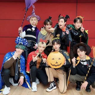a group of young people posing for a photo with pumpkins on their heads and costumes Stray Kids Halloween Laptop Felix Skz Halloween Costume, Stray Kids Costume Ideas, Stray Kids Halloween Costume Ideas, brown