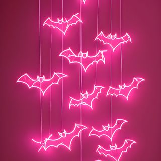 a bunch of bats hanging from strings in the air with neon lights on them, against a dark background Dark Pink Halloween Diy Halloween Party Ideas, Halloween Neon Decor, Neon Pink Bat Decorations, brown
