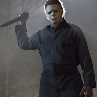 a man with a knife in his hand Halloween 1978 Michael Myers dim gray